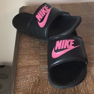Nike slides with pink nike logos.